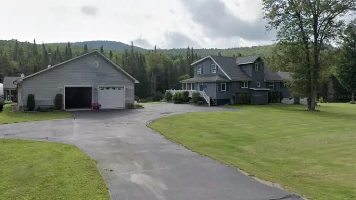 Exterior of a grey home with large garage